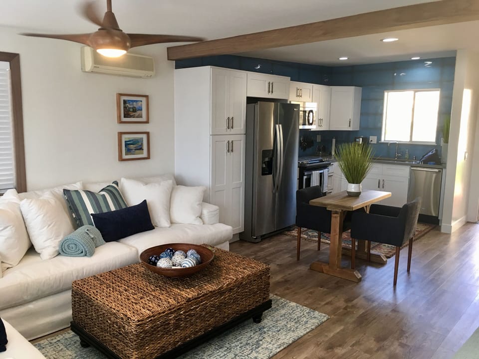 Living room 
well appointed kitchen. 
Table and two upholstered chairs.
