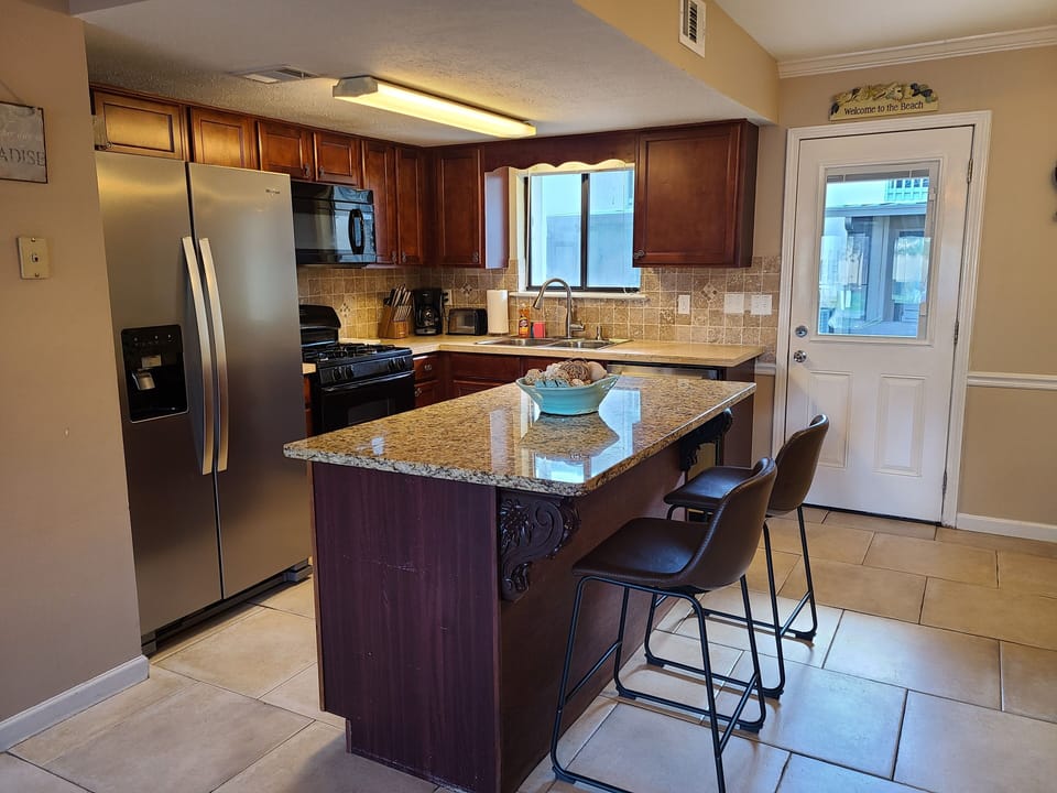 Kitchen with stainless steel appliances and granite countertop
