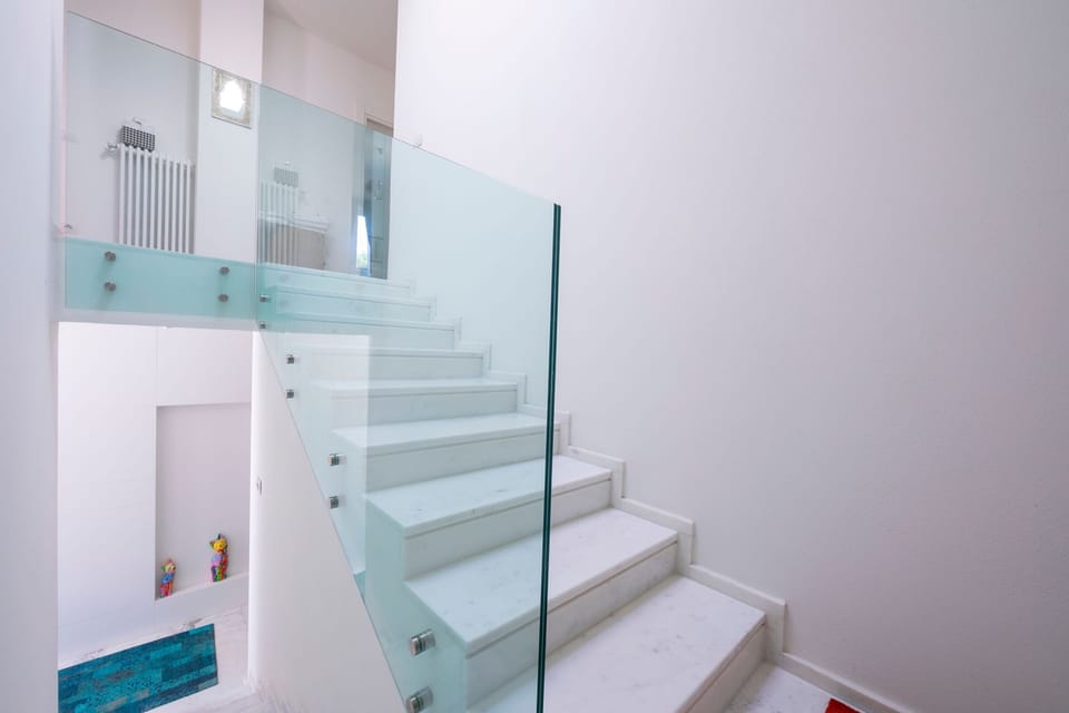 Stairs to the first floor night area with a magnificent crystal rail