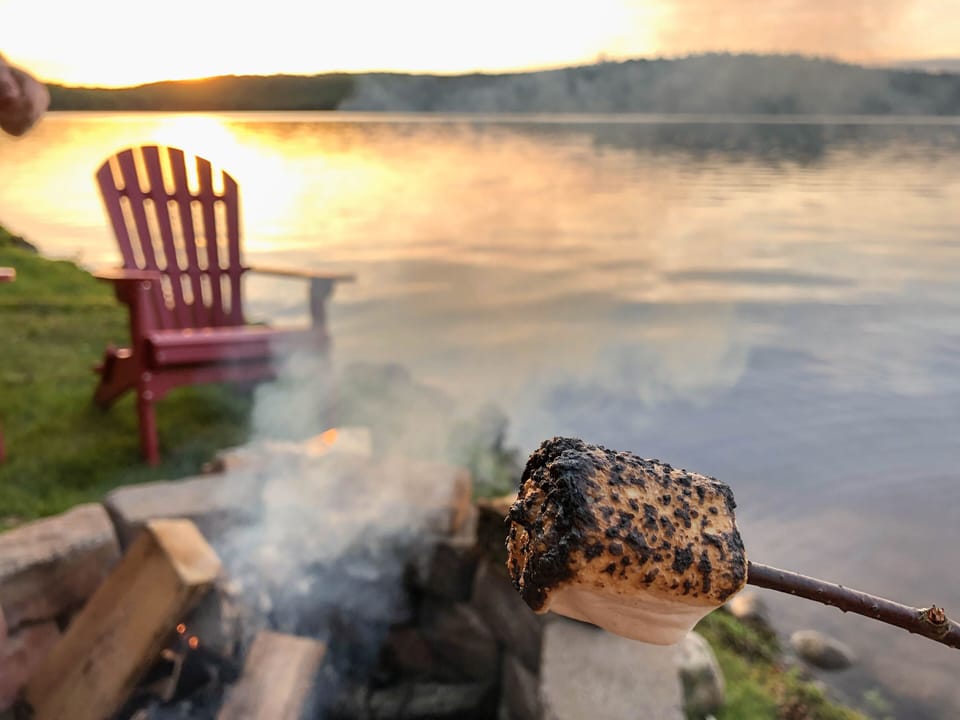 Roasting marshmallows at the fire pit over Lake Colby