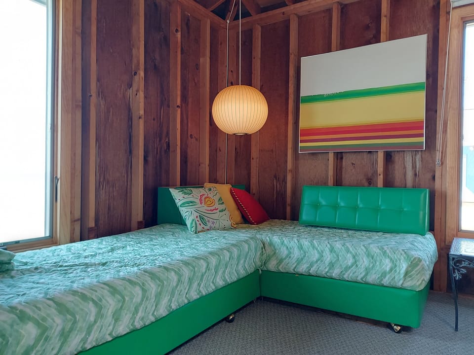 beach-side twin beds on wheels with privacy curtain surround