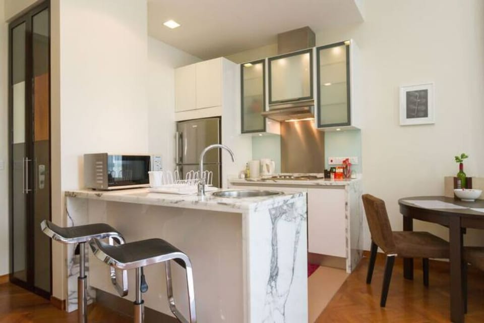 Kitchen with bar seating and dining table.