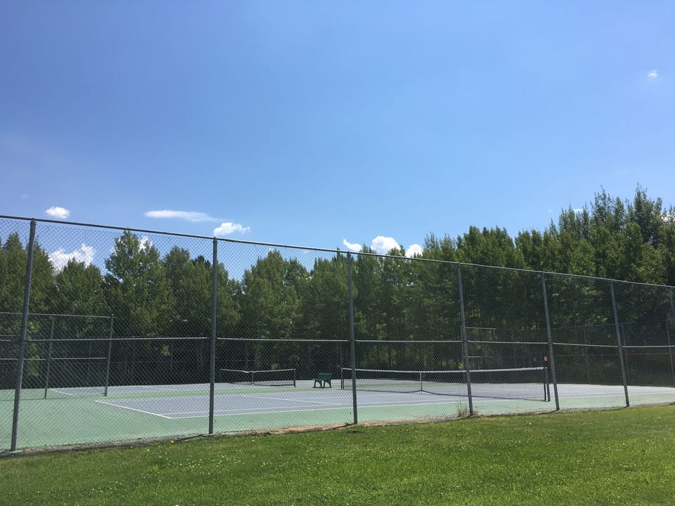 2 tennis courts are right outside your front door.
