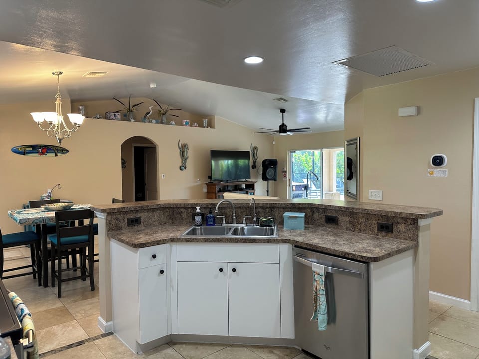Kitchen island with sink and dishwasher.