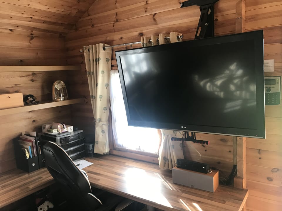 Shows TV pulled down for viewing. 