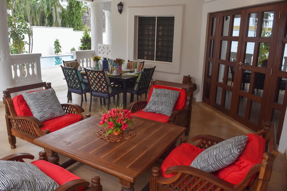 Outdoor dining area facing the pool