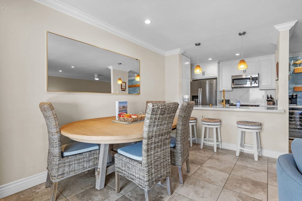 Gather around the spacious dining table with comfortable seating and a clear view into the open concept kitchen and living area