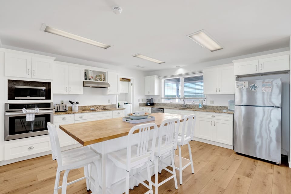The kitchen is fully equipped and offers bar seating at the island
