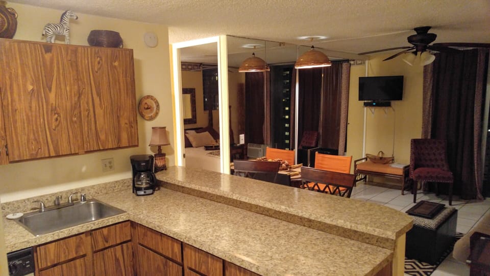 Kitchen breakfast bar, open to living room. Bedroom on left, bathroom on left