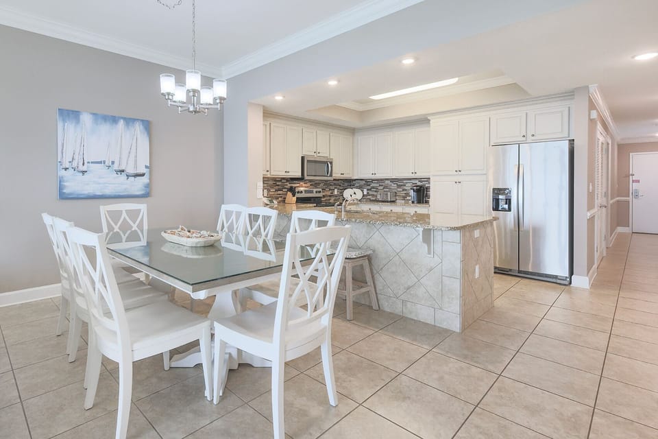 Gather around the stylish dining table, where laughter and conversation flow effortlessly in this inviting space