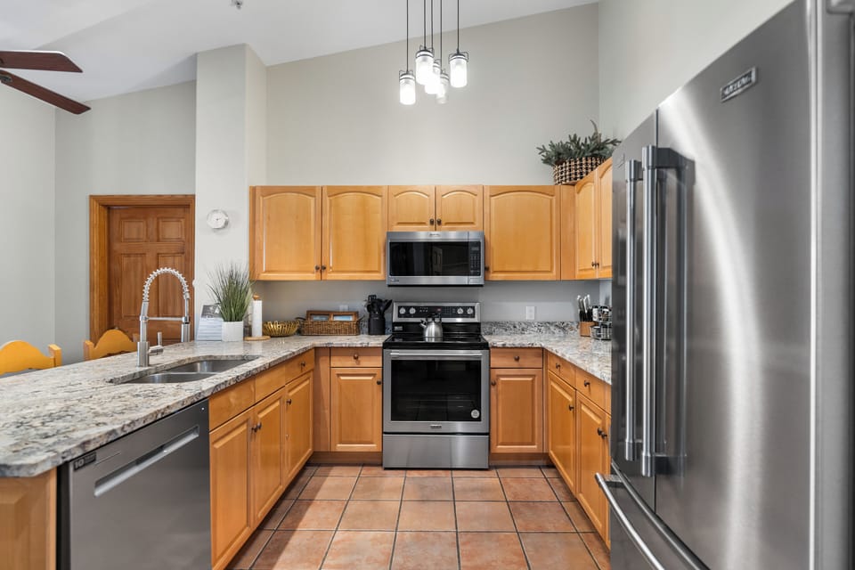 Updated full kitchen with stainless steel appliances, and breakfast bar with seating for three.