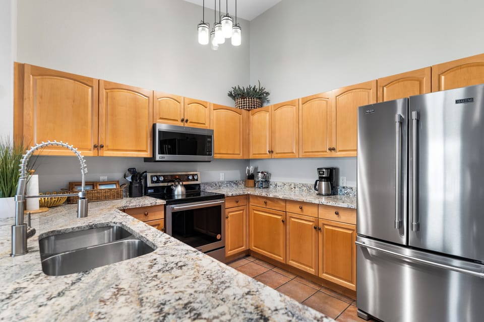 Updated full kitchen with stainless steel appliances, and breakfast bar with seating for three.