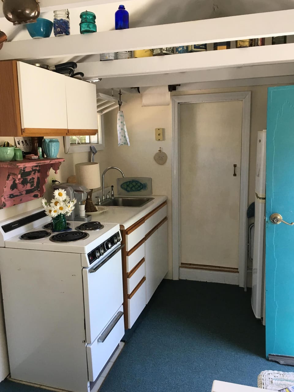 Kitchen and door to step up to bathroom