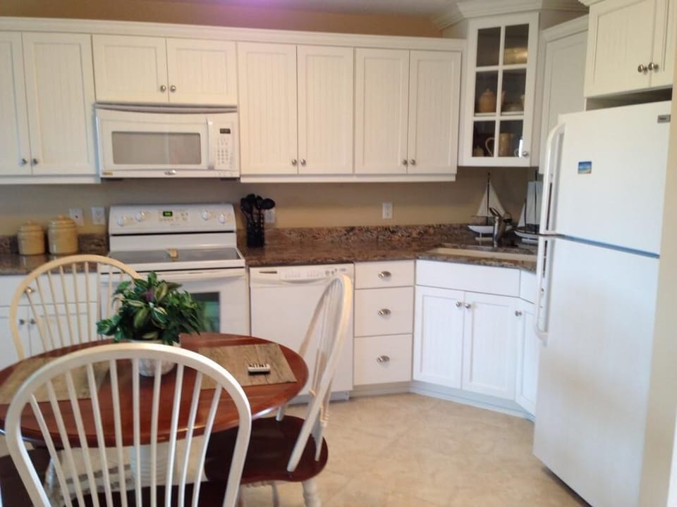 Custom wainscot kitchen cabinets with granite counters.