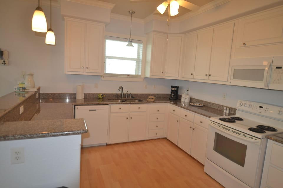 Spacious and bright kitchen with lots of cabinets.