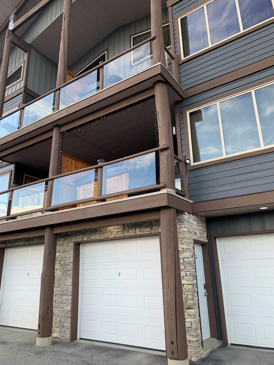 Unit #3 garage and man door. Deck and hot tub above are part of the unit.