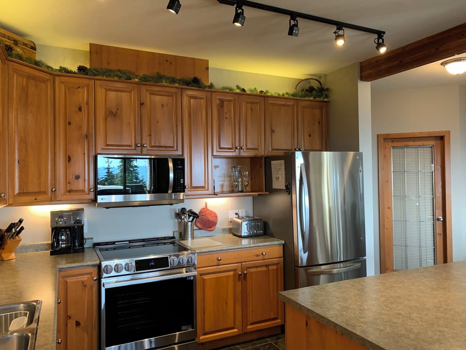 Kitchen with new LG stainless steel appliances.
