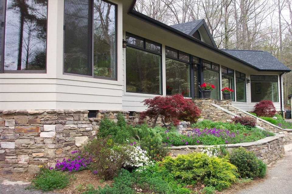 Front of the house looking out onto the waterfall and pond, 18 wooded acres.
