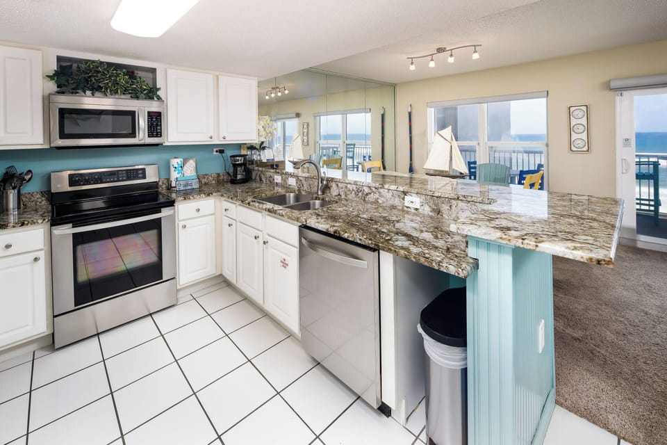 Kitchen - Featuring granite counter tops and stainless steel appliances. Fully equipped to help you create a delicious meal.
