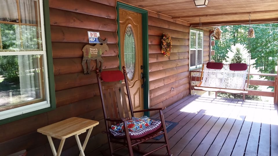 The front deck with the  Outer Banks rope swing and rocking chairs say, "Relax!"
