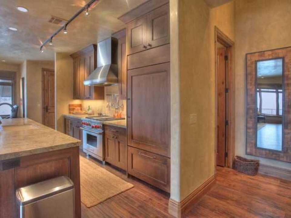 Kitchen has gas range and built-in frig and pantry
