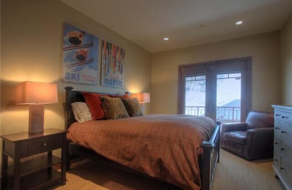 Third bedroom with balcony and views of mountain slopes