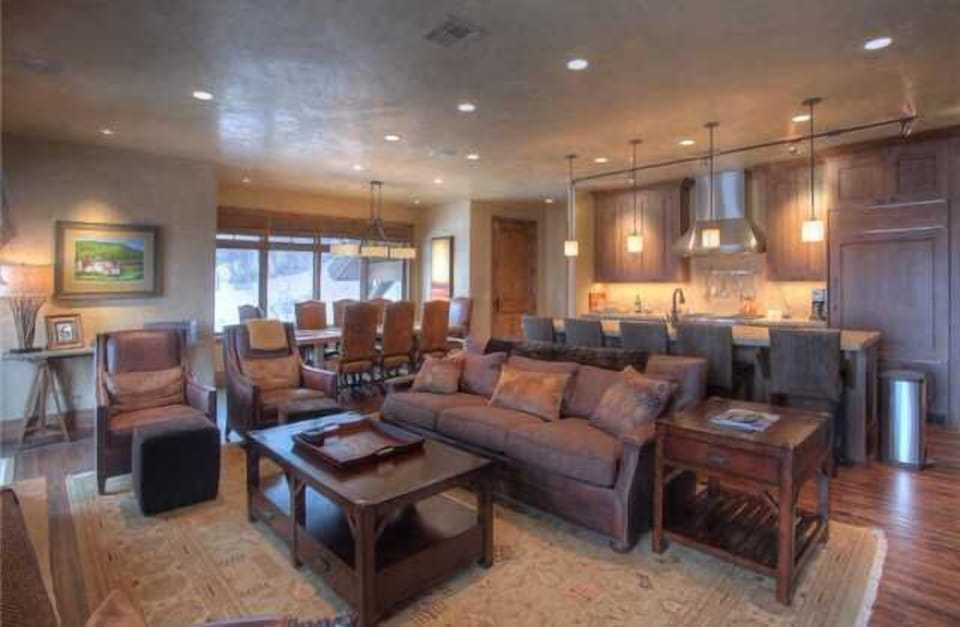 Great room with kitchen and dining area in background