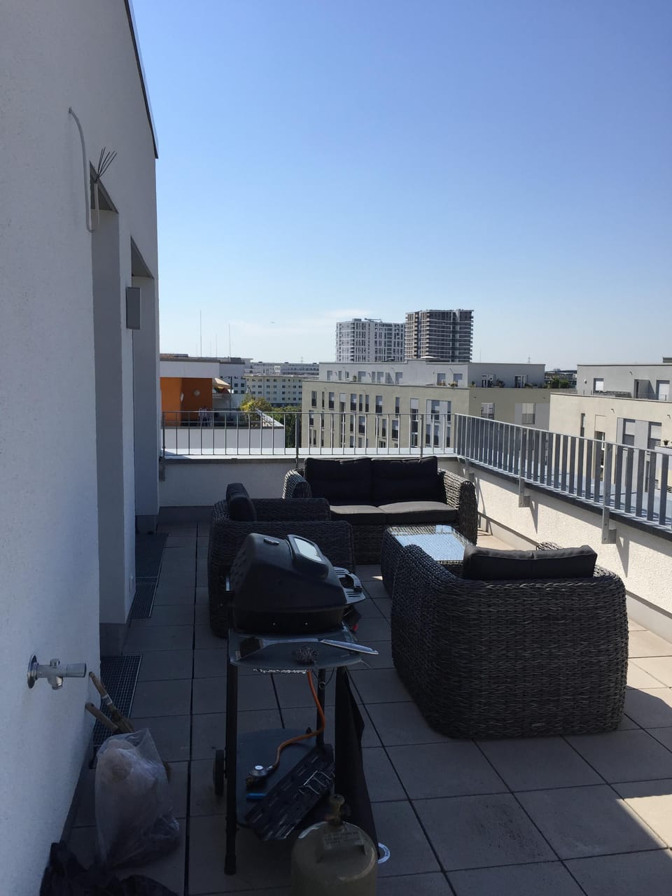 huge
 walk out  terrace with gas grill and rattan furniture