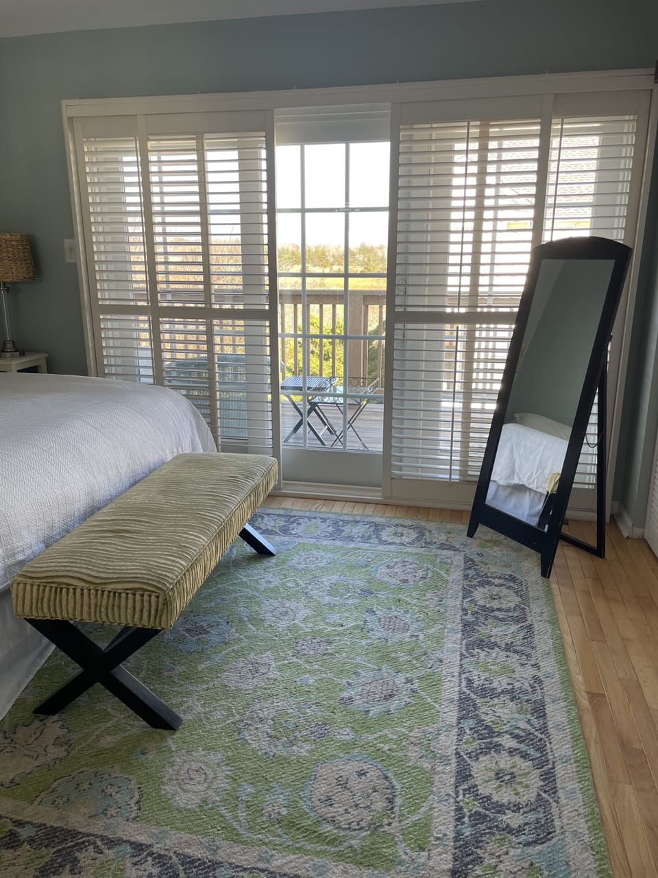 main bedroom with sliders to deck overlooking salt marsh