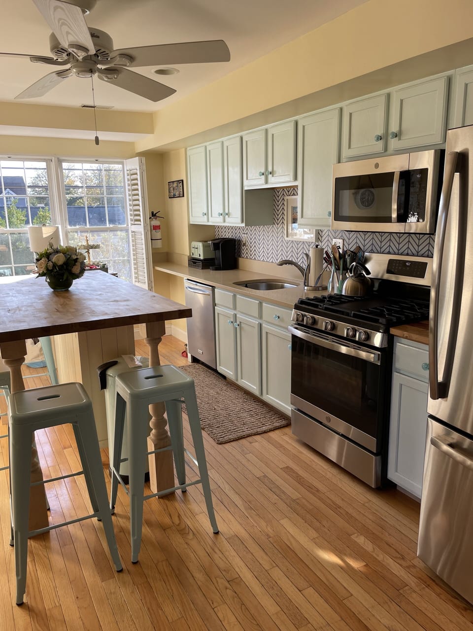 modern kitchen with stone counters, and butcher block island