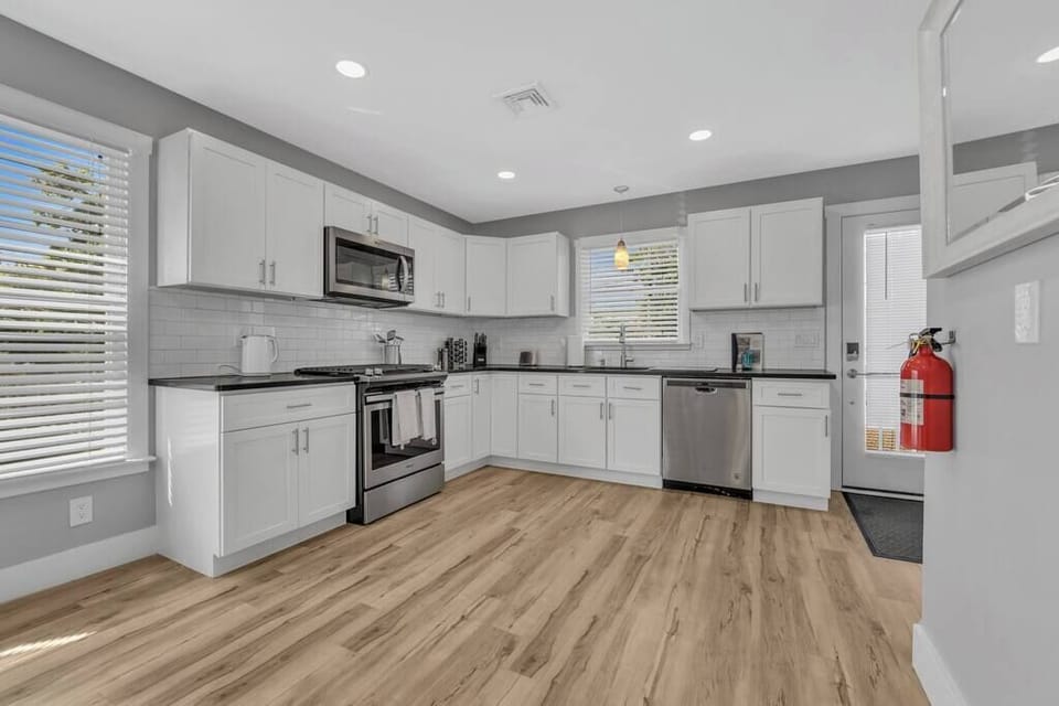 Recently renovated kitchen features all stainless steel appliances and gleaming quartz countertops.