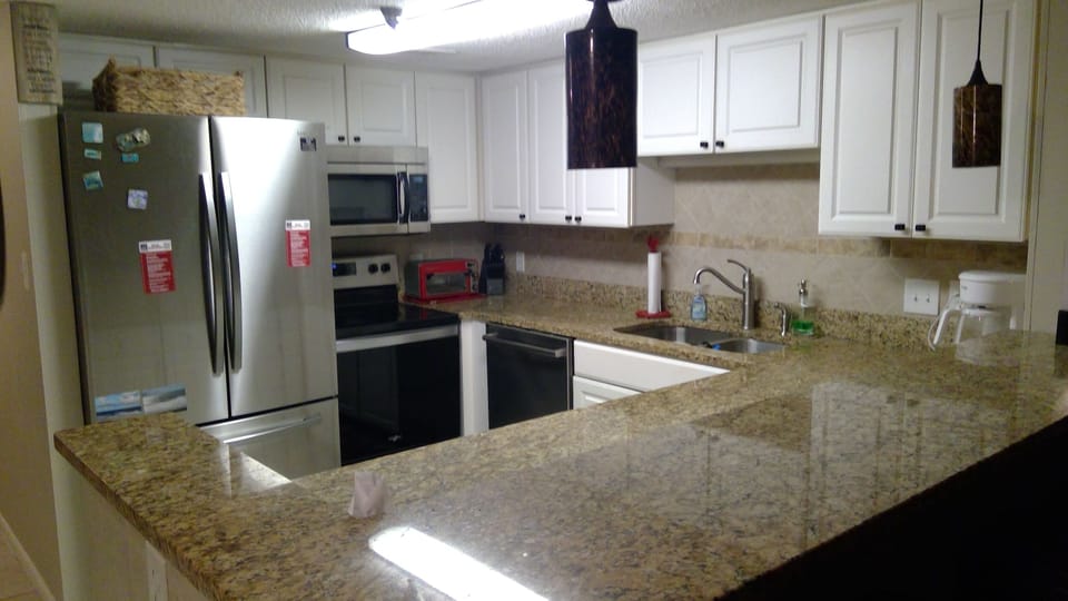 Kitchen with new stainless steel appliances. 