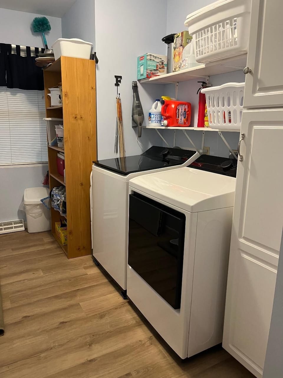 ample storage space in first floor laundry supplied with basic cleaning needs