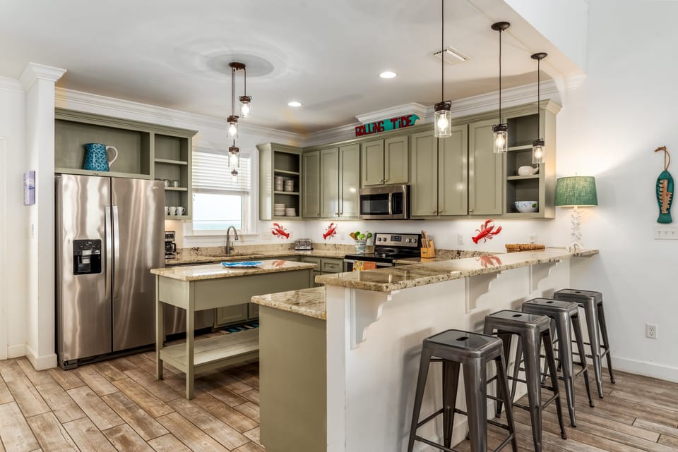 fully equipped kitchen with breakfast bar seating for 4.