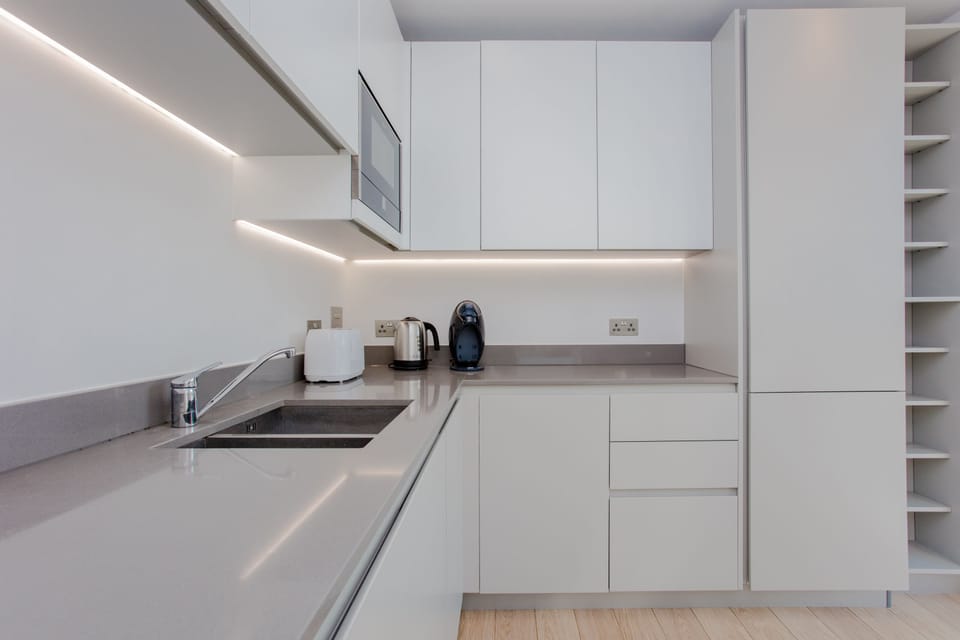 Open plan kitchen with toaster, kettle and coffee maker