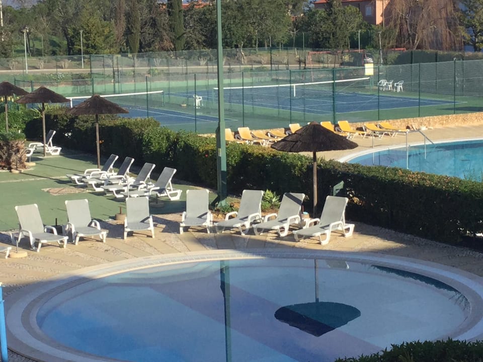 View of the pools and tennis courts from the rear balcony.