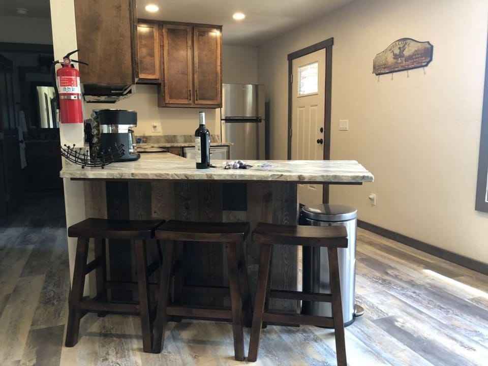 Bar seating. Coffee table pops up for additional dining space. 