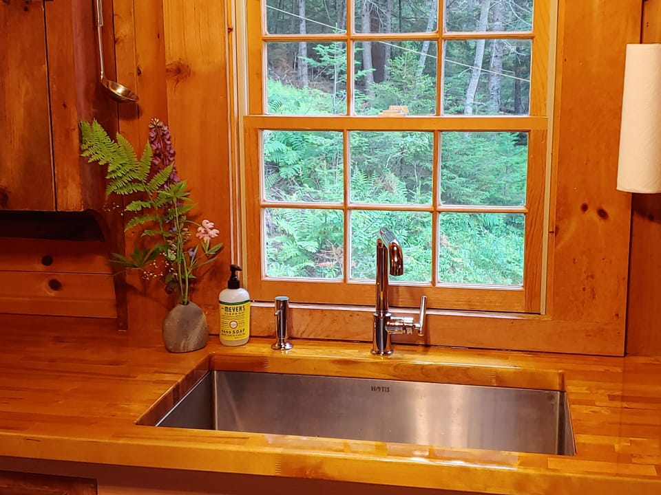 Stunning old growth wood countertops remind you that you're in woods in Maine
