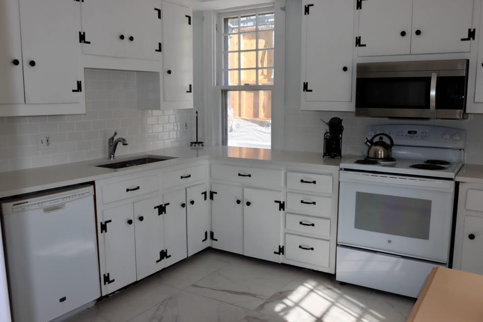 Quartz counters in this sunny kitchen fully loaded with all you need to cook