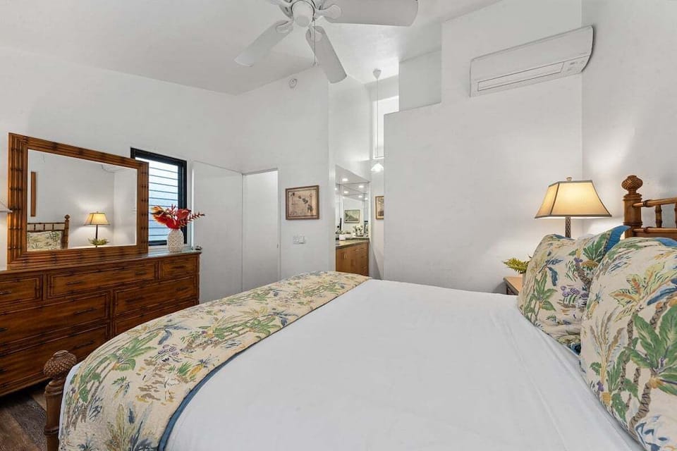 Bright bedroom with queen bed, wooden furniture, and soft lighting for ultimate comfort.