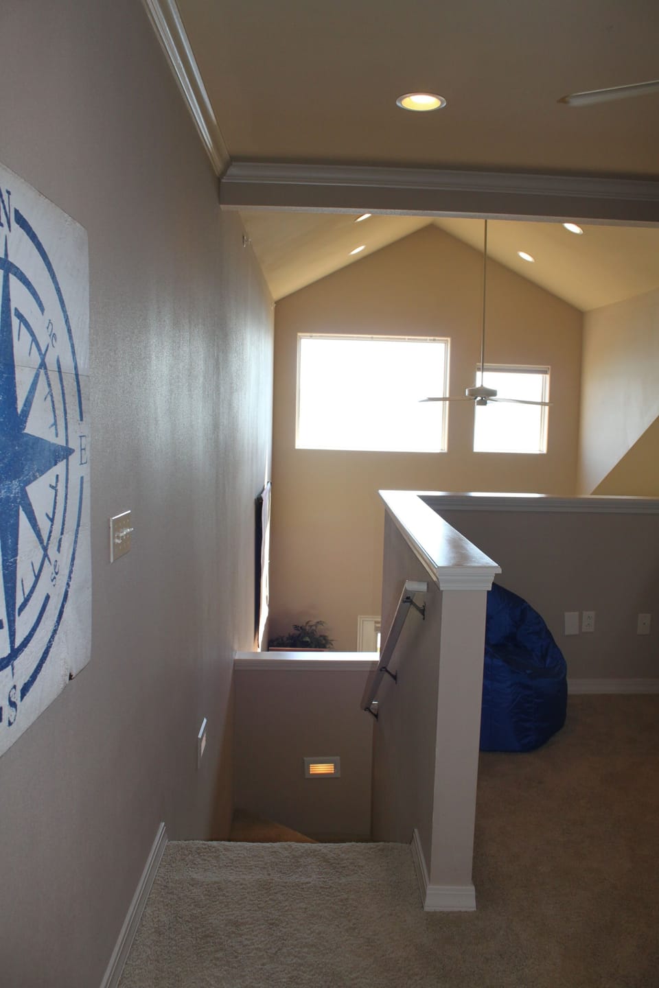 Loft Bedroom stairway showing open wall area. Privacy shade rolls down to ledge!