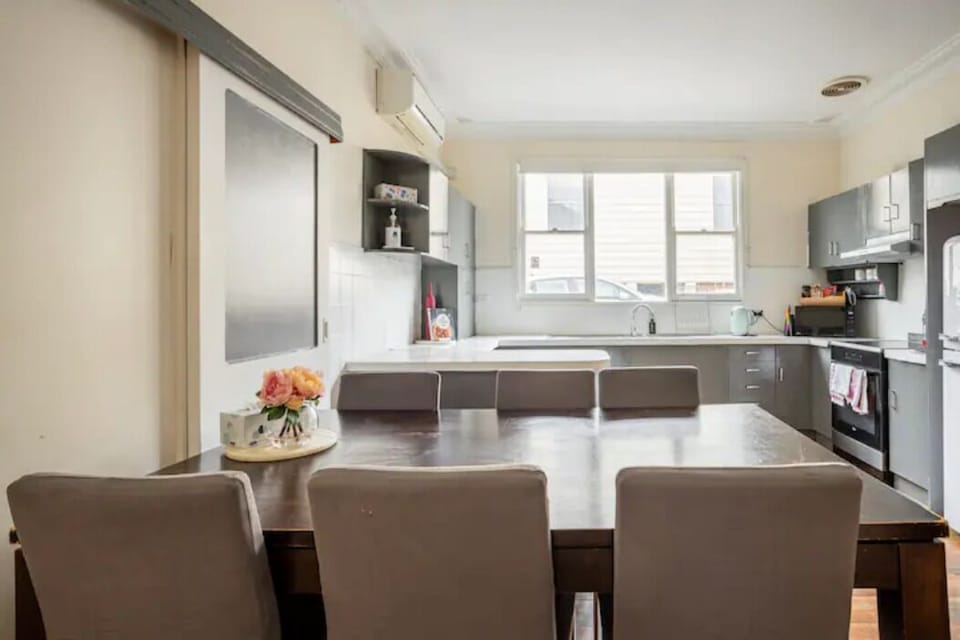Old laminate kitchen by split Air-conditioner on the left wall.