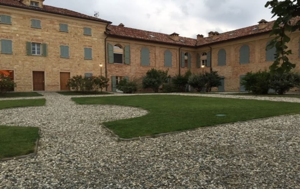 The apartment (in the corner below the open shutters) from the main courtyard