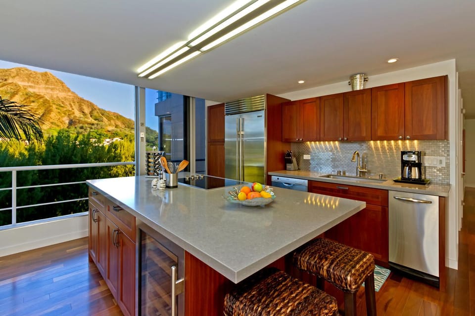 Open-concept kitchen with center island, perfect for cooking while enjoying views of Diamond Head and beyond.