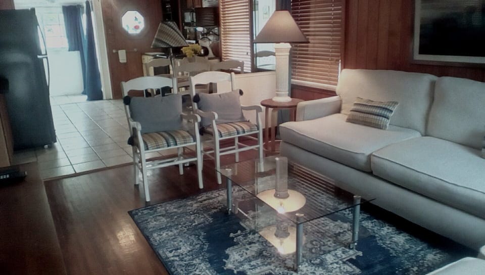 Living room has two sofas and extra chairs. 