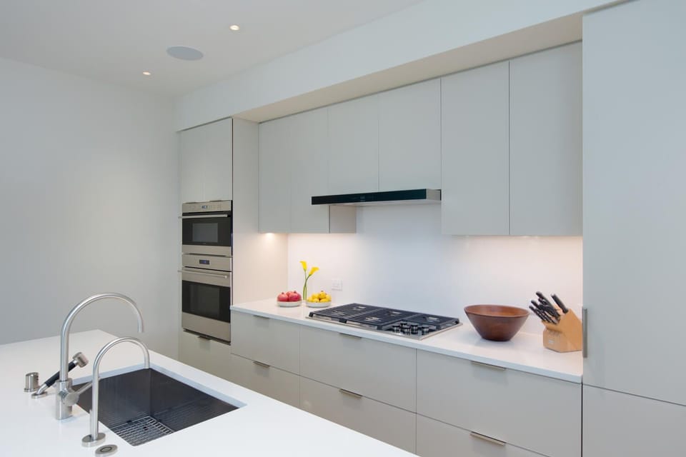 Channel your inner chef in this sleek, modern kitchen outfitted with high-end appliances and clean lines for effortless cooking and entertaining.