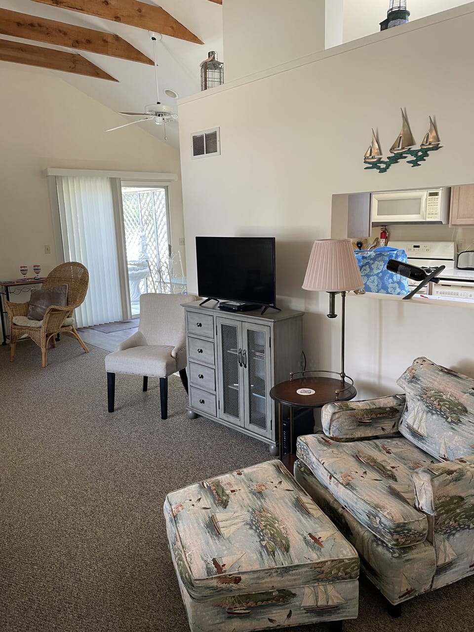Living room with chairs an sofa with a bay window