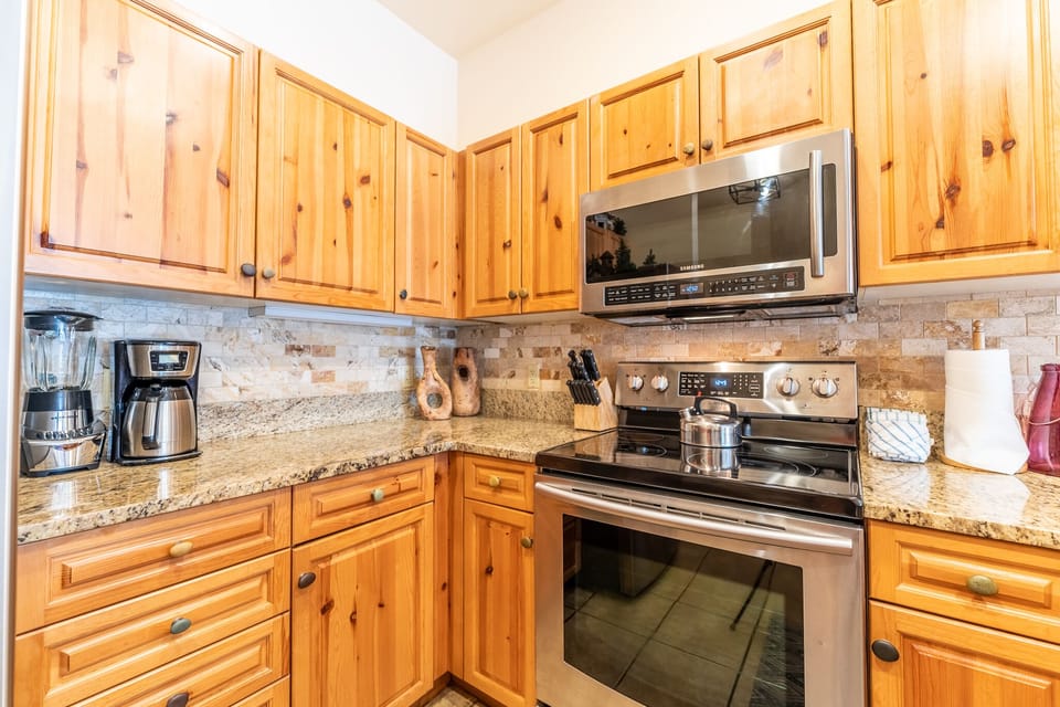 Updated kitchen with stainless steel appliances and granite countertops.