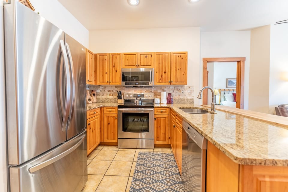 Updated kitchen with stainless steel appliances and granite countertops.