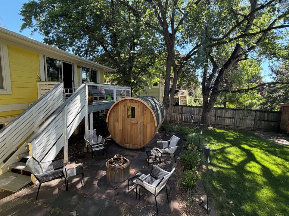 Barrel Sauna and fire pit in backyard